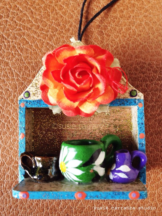 ornament: large orange rose with miniature clay pottery...