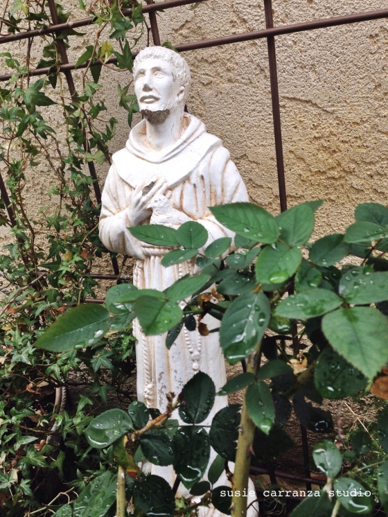 St. Francis statue after a rainfall. susie carranza studio